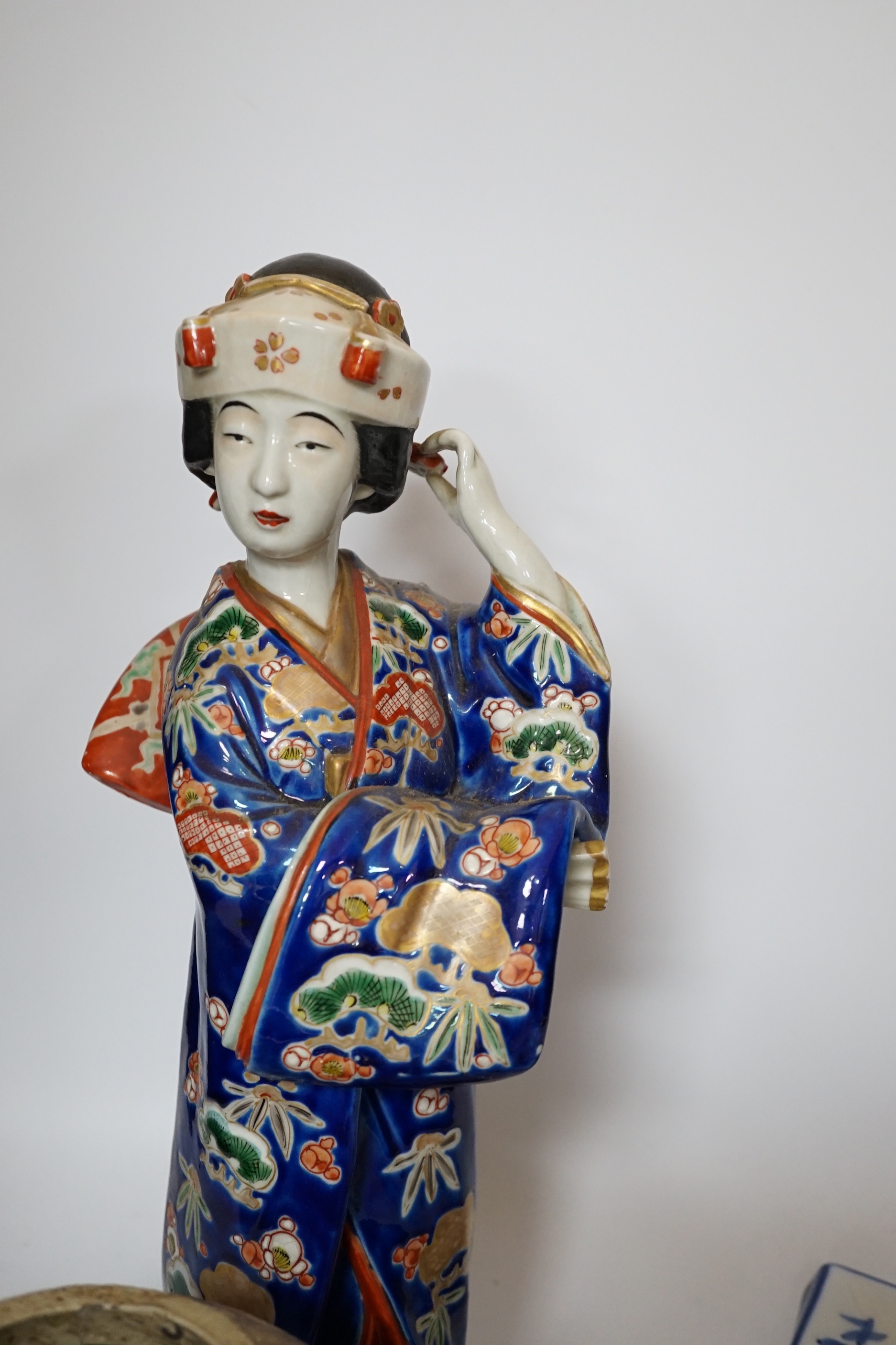 A 20th century Chinese porcelain figure, a stoneware jar, a ‘dragon’ inkstone and a Japanese dish, figure 37cm